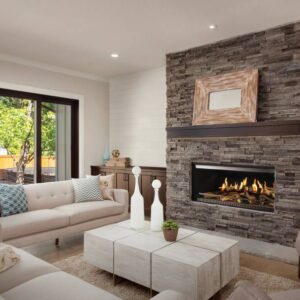 The NetZero E-One fireplace in a modern living room with a stone fireplace surround.