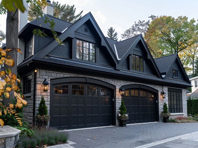 Black glass garage door enhancing a contemporary house's curb appeal.