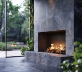Modern gas outdoor fireplace on a screened-in porch.