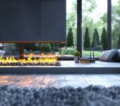 A sleek modern fireplace with a minimalist surround, set in a bright living room overlooking a garden, answering the question how do I choose the right fireplace surround for my home.