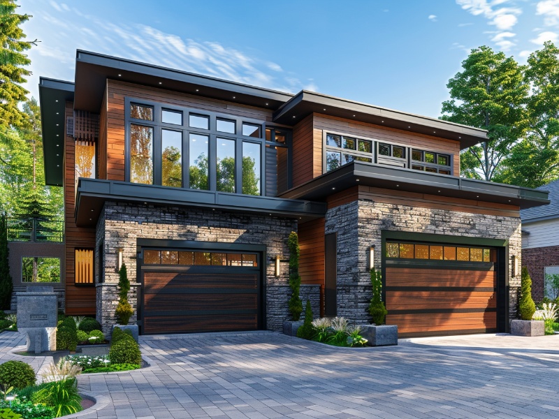 An image of a home with two different size garage doors made to blend into the design elements of the home.