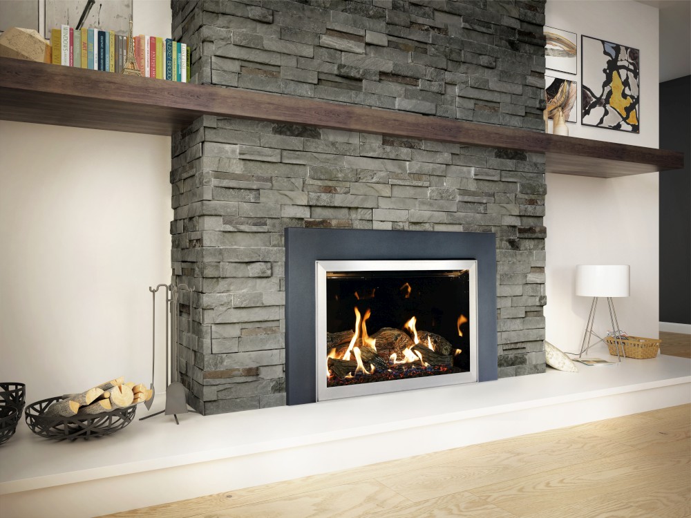 A modern fireplace set in a stylish stone wall with a sleek black frame, books, and decor on the mantel.