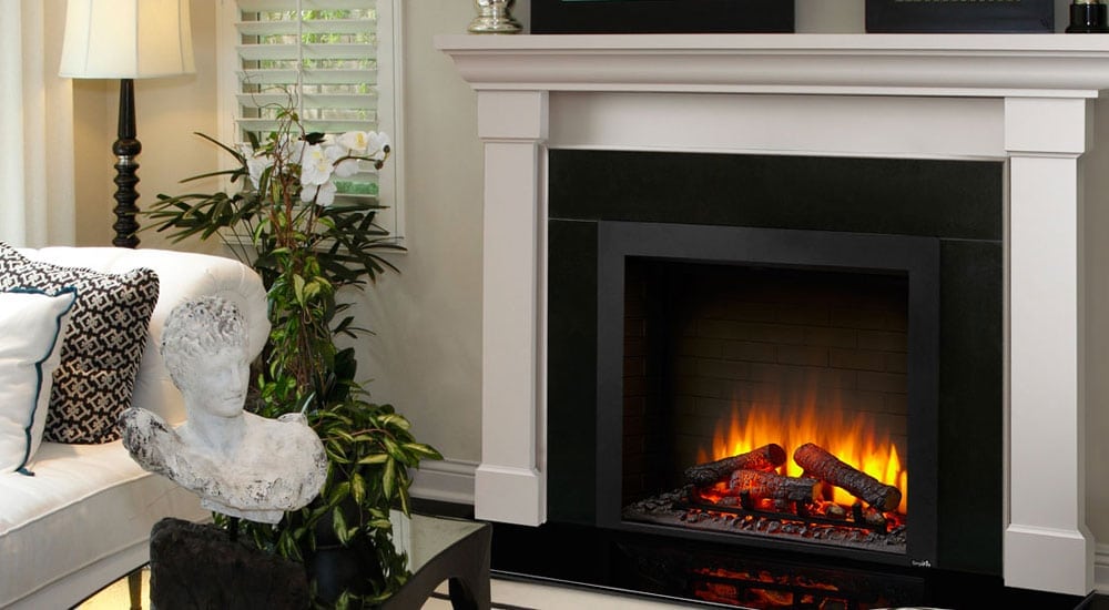 A cozy living room with a modern electric fireplace, a white sofa, decorative pillows, a sculptural bust, and a potted plant.